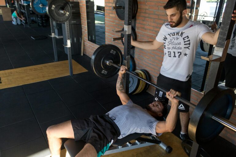 Athlete lifting weights – ideal candidate for Zennergy’s deep tissue sports massage therapy